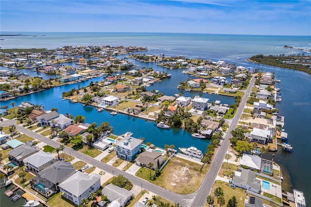 aerial view of residential area featuring a large body of water