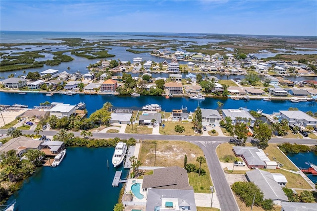 aerial view of residential area featuring a nearby body of water