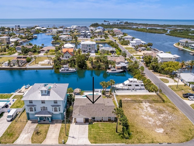 aerial view of residential area featuring a large body of water