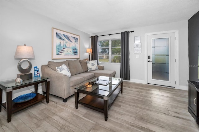 living room with light wood-type flooring and baseboards