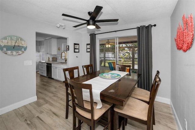 dining room with light wood-type flooring, baseboards, and ceiling fan