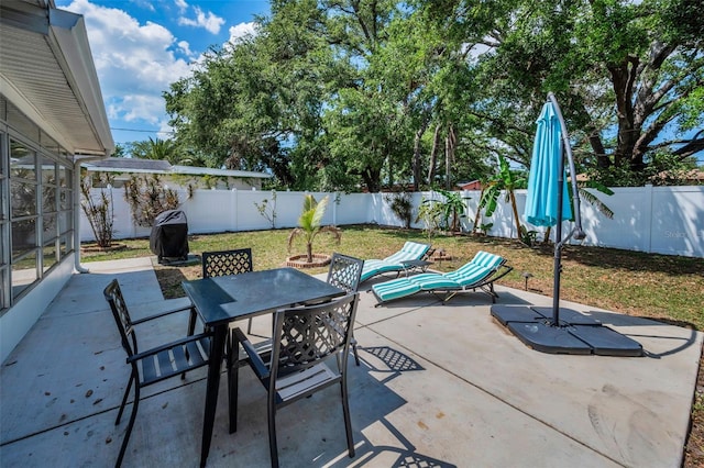 view of patio with outdoor dining area and a fenced backyard