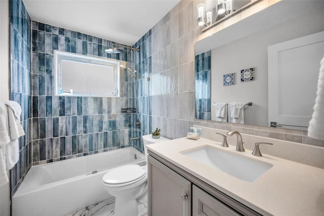 full bathroom featuring bathing tub / shower combination, tile walls, toilet, and vanity
