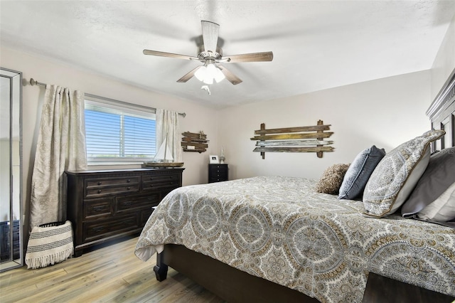 bedroom featuring a ceiling fan and light wood-style flooring
