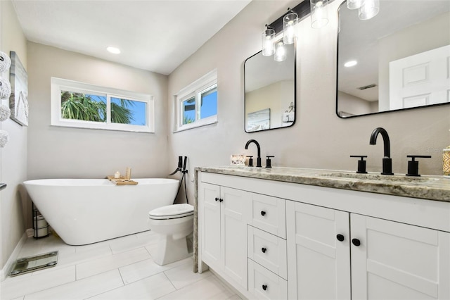 bathroom featuring a sink, a soaking tub, double vanity, and tile patterned flooring