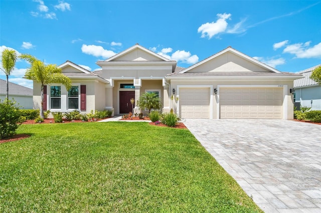 15912 42nd Gln E, Parrish, FL 34219 - ranch-style home with stucco siding, decorative driveway, a garage, a front lawn, and a tile roof
