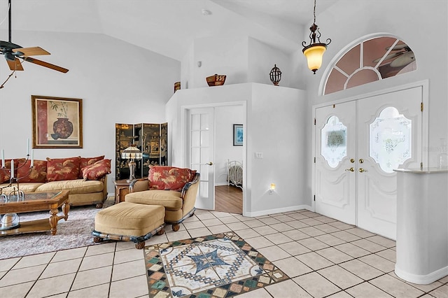 foyer featuring ceiling fan, high vaulted ceiling, french doors, and light tile patterned floors