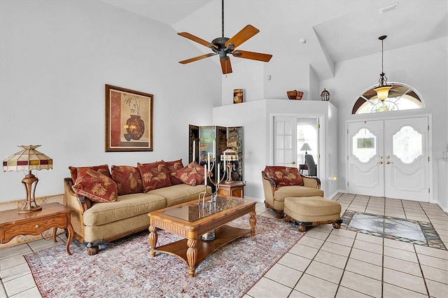 living area featuring high vaulted ceiling, a ceiling fan, french doors, and light tile patterned floors