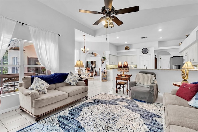 living room with light tile patterned flooring, baseboards, ceiling fan with notable chandelier, visible vents, and recessed lighting