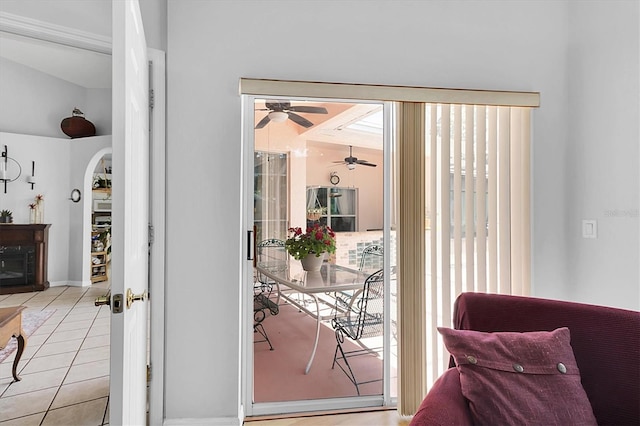 interior space with arched walkways and ceiling fan