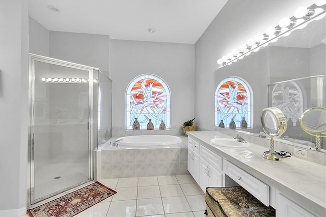 full bathroom featuring tile patterned floors, a garden tub, and a shower stall