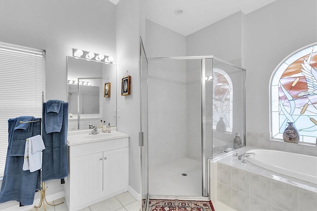 bathroom with tile patterned flooring, vanity, a bath, and a shower stall