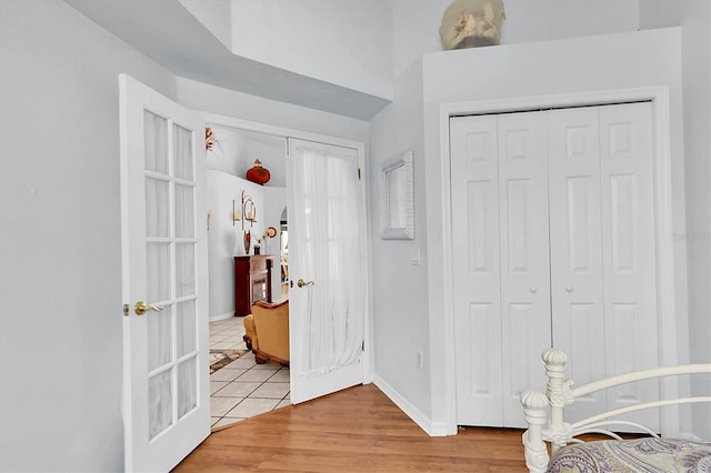 foyer entrance with baseboards and light wood-style flooring