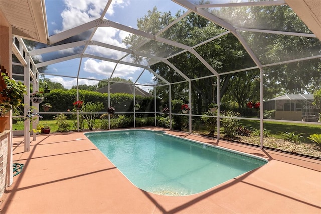 outdoor pool featuring glass enclosure and a patio area