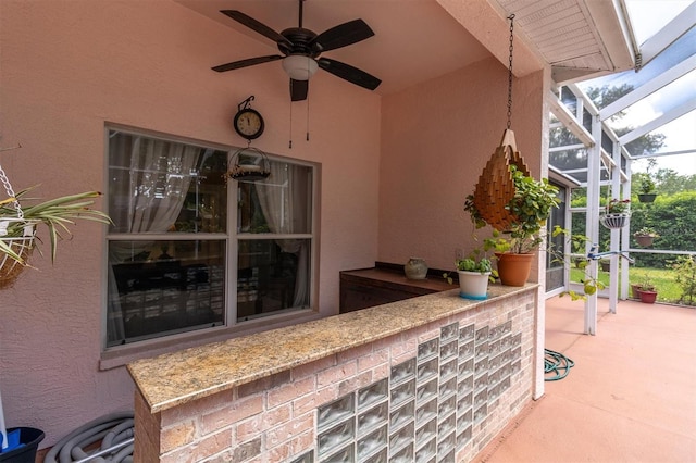 view of patio / terrace with a lanai and ceiling fan