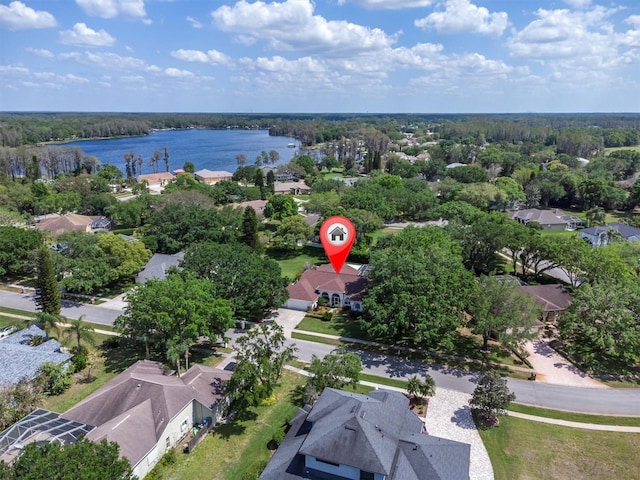 aerial view featuring a water view and a wooded view