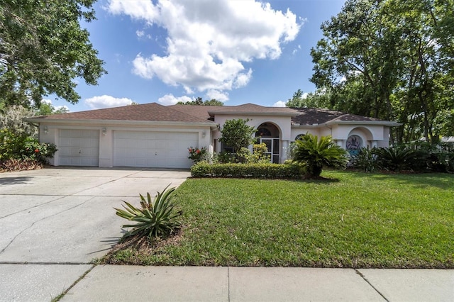 view of front of property featuring a front lawn, stucco siding, a garage, and concrete driveway