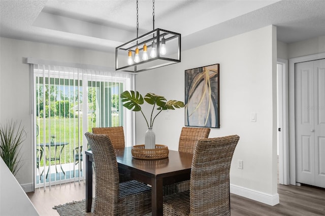 3416 Lema Dr, Spring Hill, FL 34609 - dining area with baseboards, an inviting chandelier, wood finished floors, and a textured ceiling