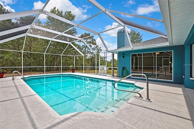 swimming pool with a patio and glass enclosure