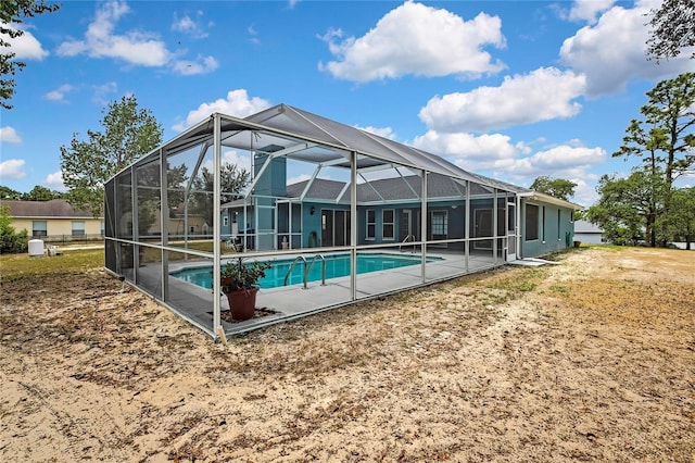 outdoor pool with a patio and glass enclosure