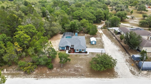 view of subject property featuring a heavily wooded area