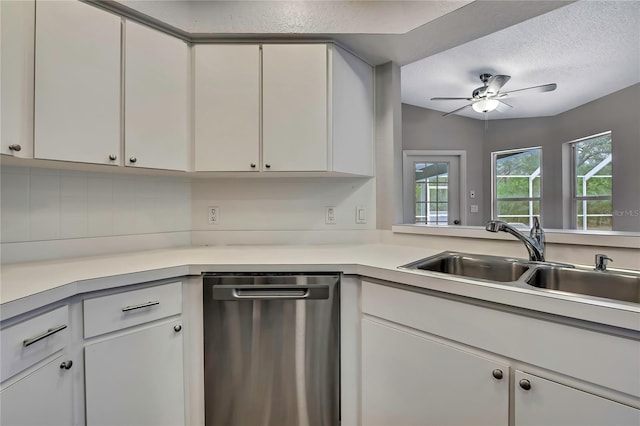 kitchen with stainless steel dishwasher, a sink, light countertops, ceiling fan, and a textured ceiling