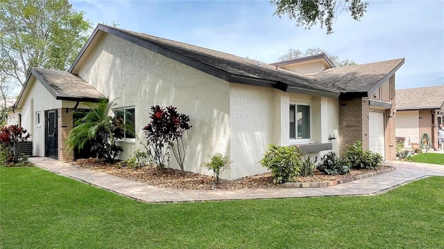view of property exterior featuring stucco siding, driveway, a garage, and a yard