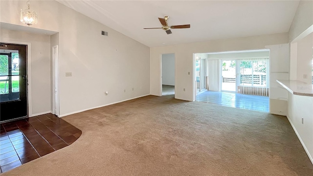 unfurnished living room with a wealth of natural light, lofted ceiling, visible vents, and carpet flooring