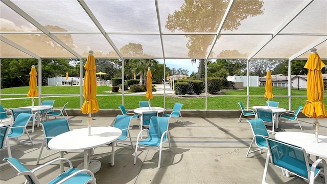 view of patio / terrace featuring glass enclosure and outdoor dining space