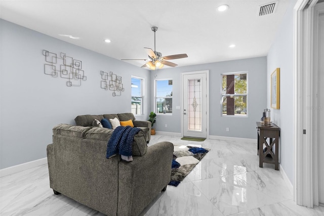 living room with baseboards, visible vents, recessed lighting, and a healthy amount of sunlight