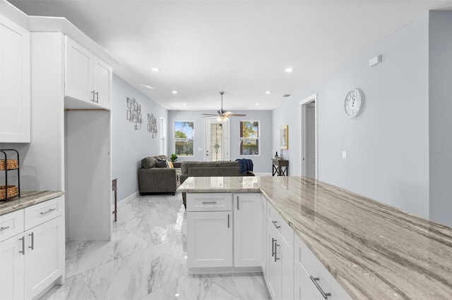 kitchen with white cabinetry, light stone countertops, marble finish floor, ceiling fan, and recessed lighting
