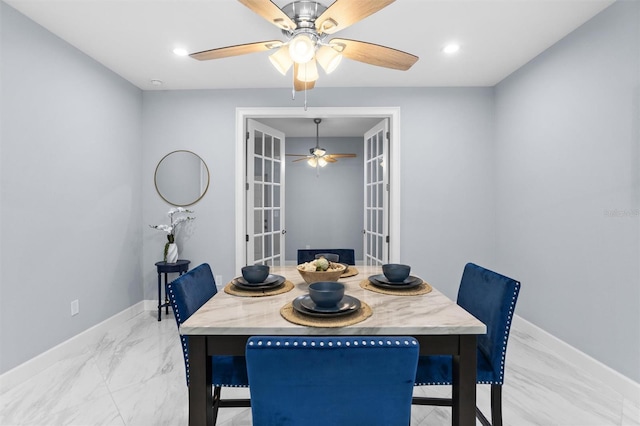 dining space with french doors, marble finish floor, baseboards, and ceiling fan