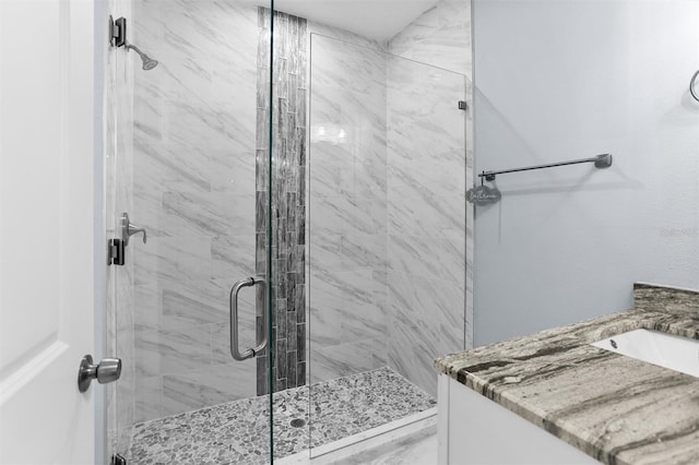 full bathroom with vanity and a stall shower
