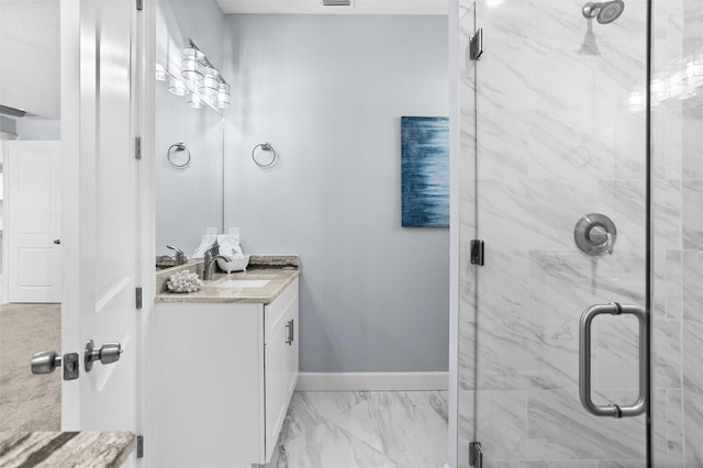 full bath with visible vents, a shower stall, baseboards, marble finish floor, and vanity