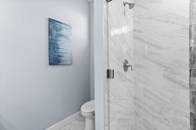 bathroom with marble finish floor, baseboards, a stall shower, and toilet
