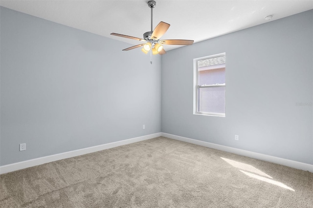 unfurnished room with baseboards, ceiling fan, and carpet floors