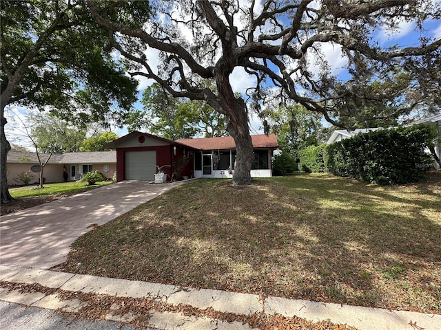 ranch-style house with a front lawn, a garage, and concrete driveway