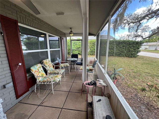 sunroom featuring ceiling fan