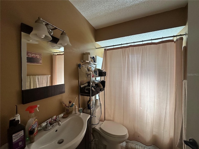 full bathroom with a shower with curtain, toilet, vanity, and a textured ceiling
