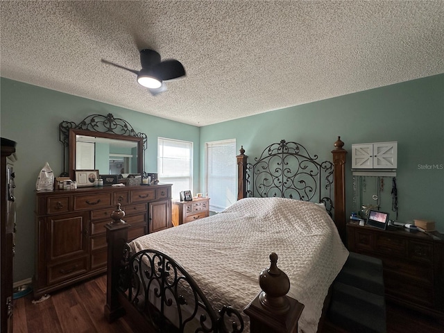 bedroom featuring dark wood-style flooring, a textured ceiling, and a ceiling fan