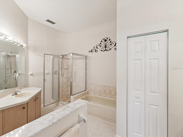 bathroom featuring a closet, a stall shower, vanity, and a bath