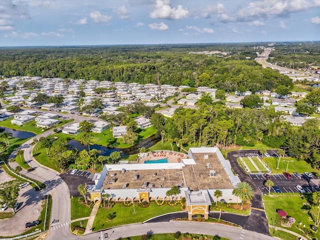 drone / aerial view with a residential view and a view of trees