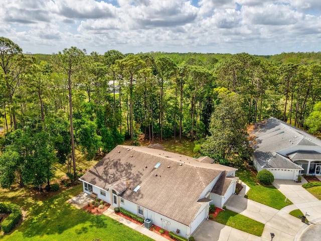 drone / aerial view featuring a wooded view