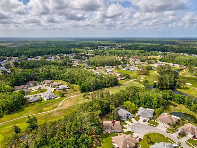 aerial view featuring a wooded view and view of golf course