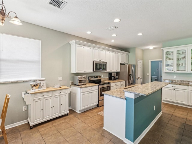 11050 Kiskadee Cir, New Port Richey, FL 34654 - kitchen with stainless steel appliances, white cabinets, glass insert cabinets, recessed lighting, and a textured ceiling