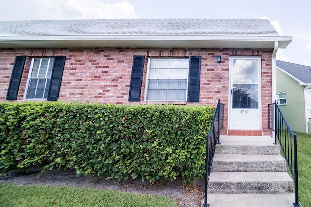 6710 Hickorywood Ln Unit 1B, New Port Richey, FL 34653 - view of front of home with brick siding and roof with shingles