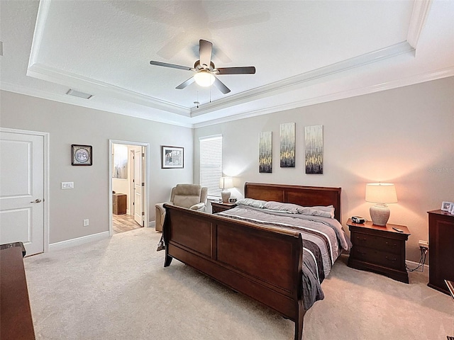 bedroom featuring light carpet and a raised ceiling