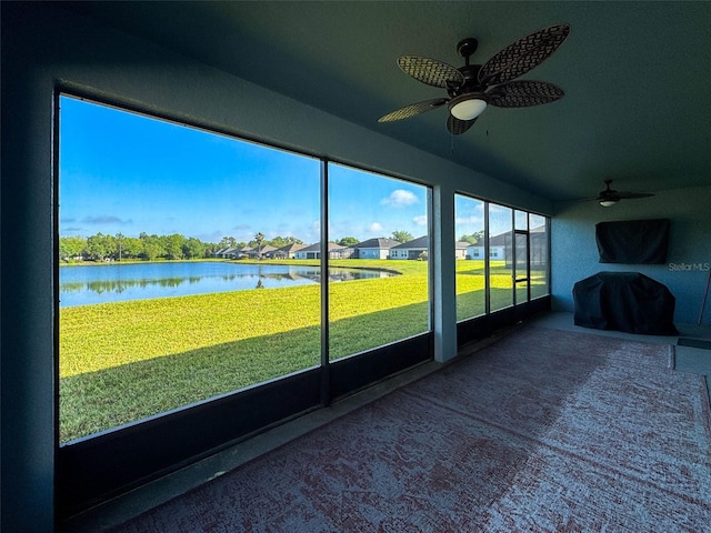 unfurnished sunroom with a water view
