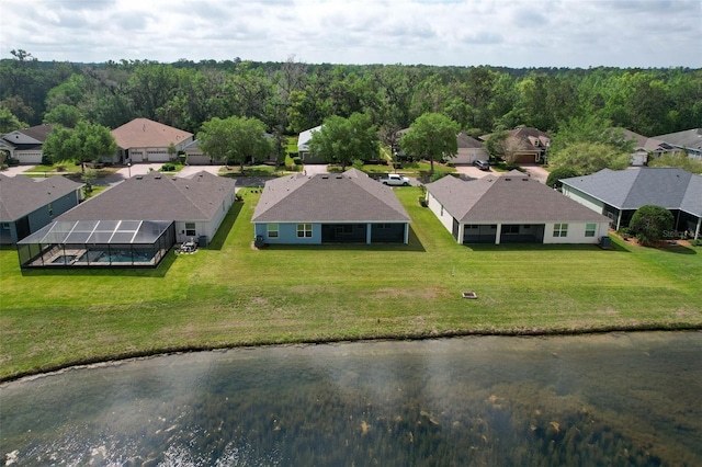 drone / aerial view with a residential view and a forest view
