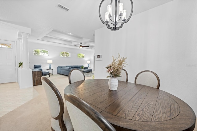 dining area featuring a tray ceiling, light colored carpet, ceiling fan with notable chandelier, light tile patterned flooring, and visible vents